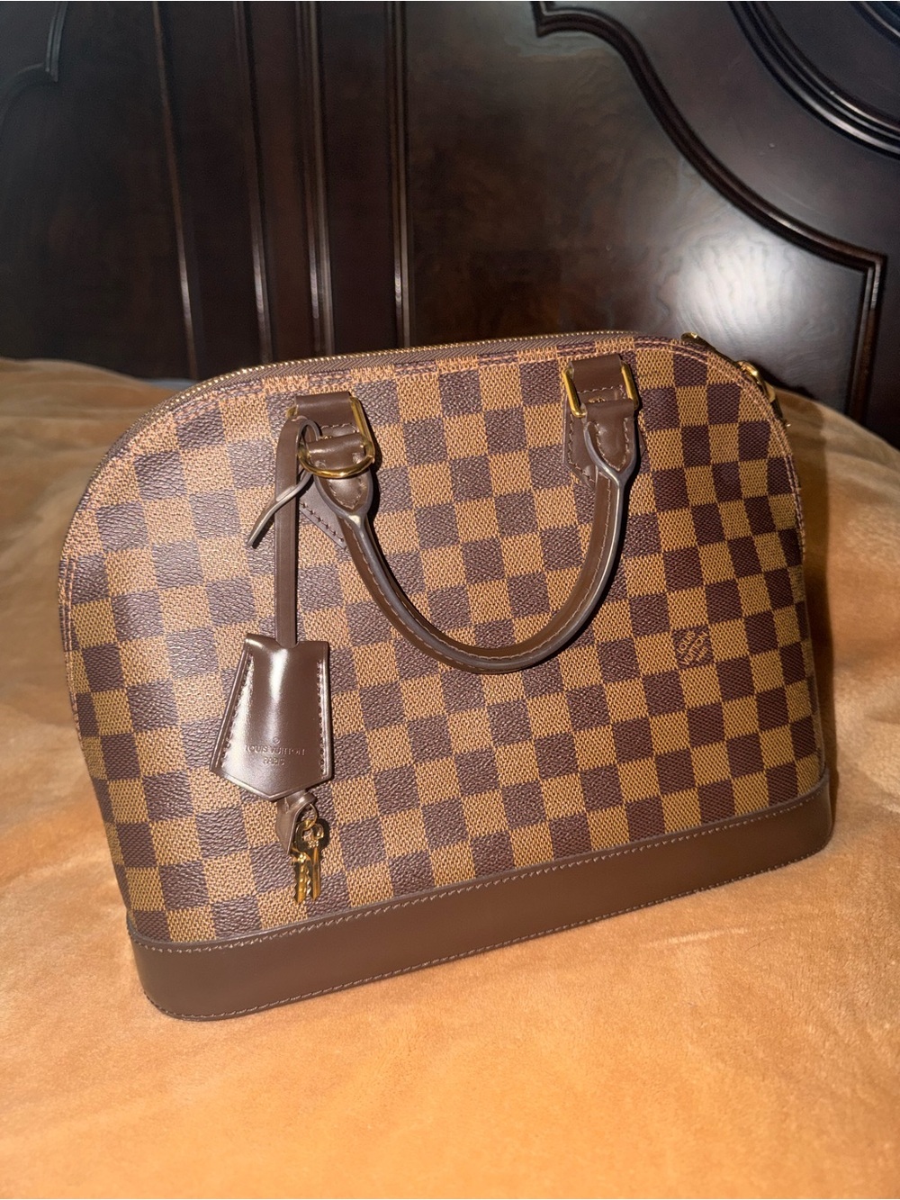 Louis Vuitton Damier Ebene Alma PM
Brown Top Handle Zip Bag w/ Lock and keys.
